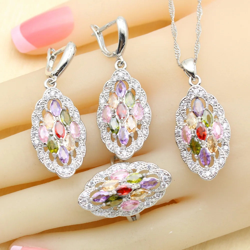 Silver jewelry set with multicoloRed gemstones on a hand