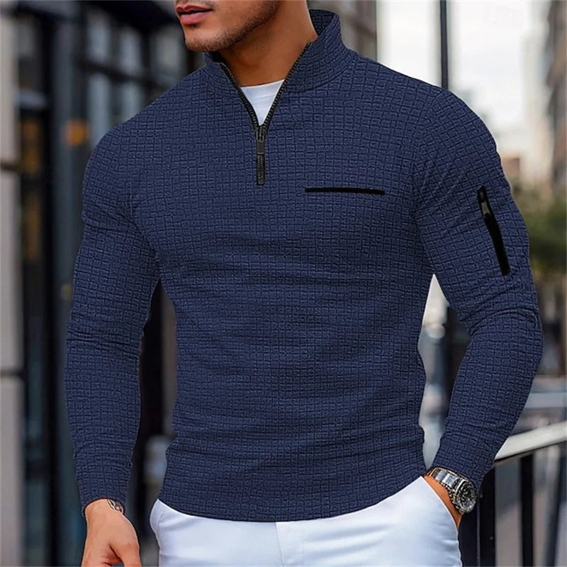 Man wearing a Blue textuRed sweater with a zipper on a blurRed city street background