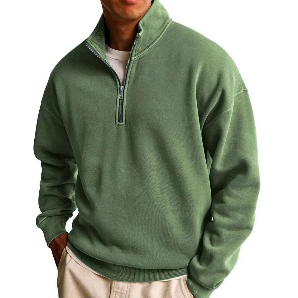 Green pullover worn by a person on a white background