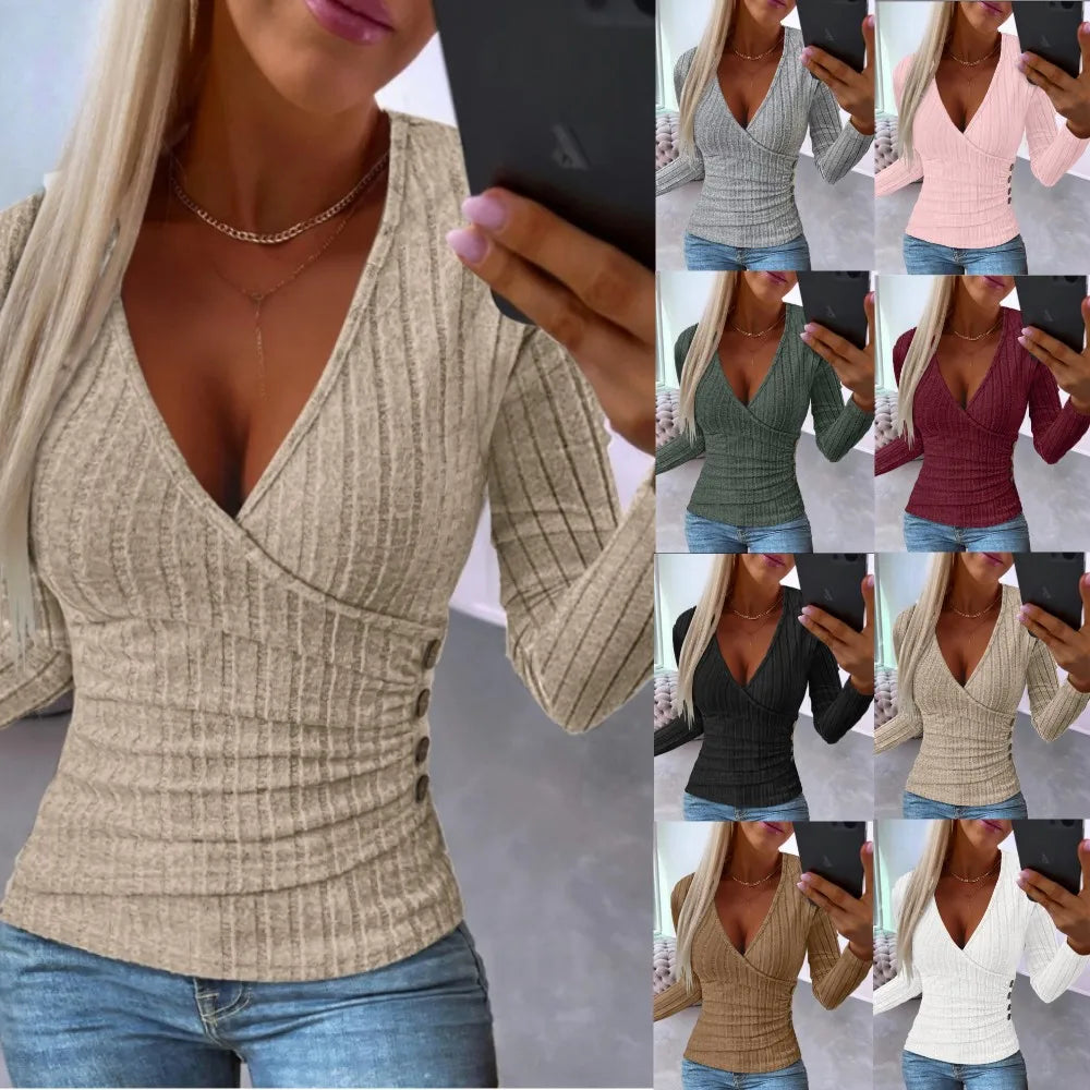 Woman wearing a beige ribbed sweater with a V-neck and buttons, holding a phone.
