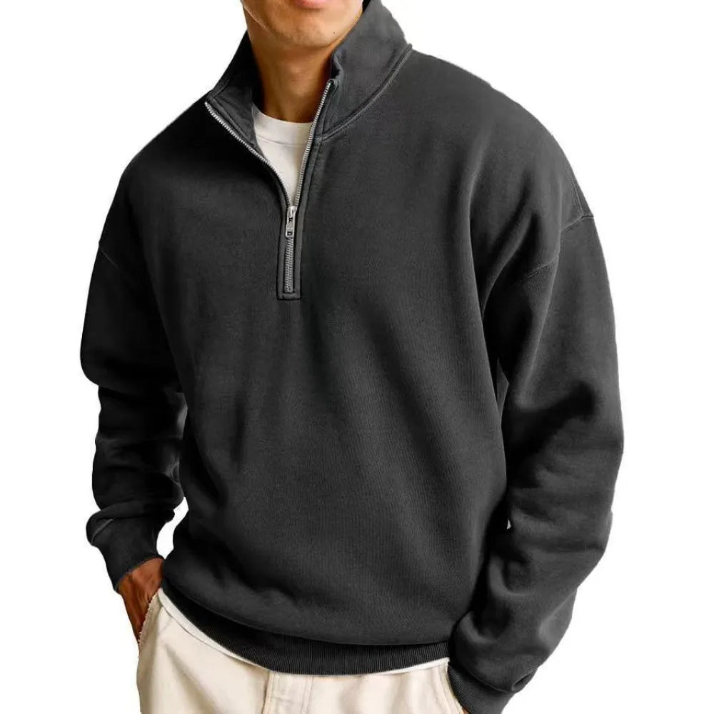 Person wearing a black quarter-zip sweatshirt on a white background