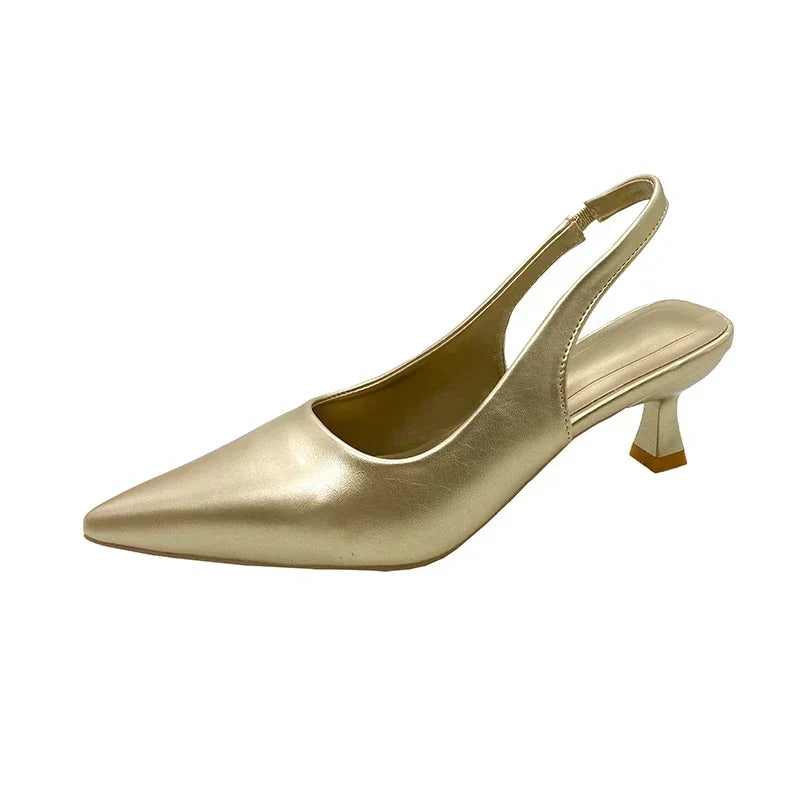 Gold slingback shoe on a White background