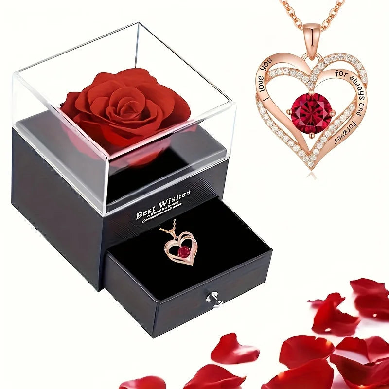 Jewelry set with Red rose in a box, heart-shaped necklace with Red gemstone, and scatteRed Red rose petals.
