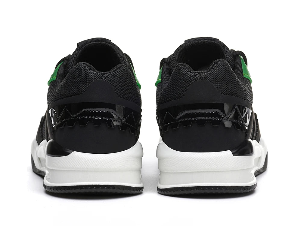 Black and White sneakers with Green accents on a White background