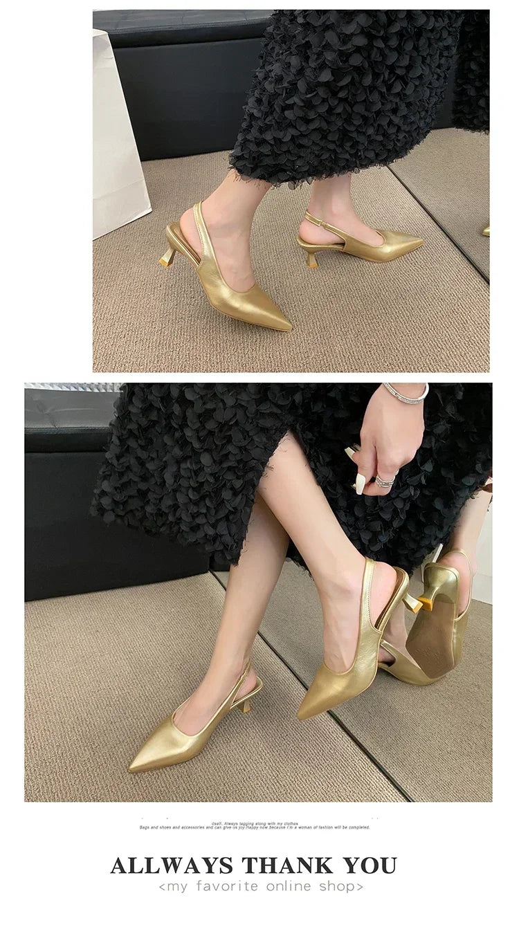 Gold high-heeled shoes worn by a person sitting on a couch.