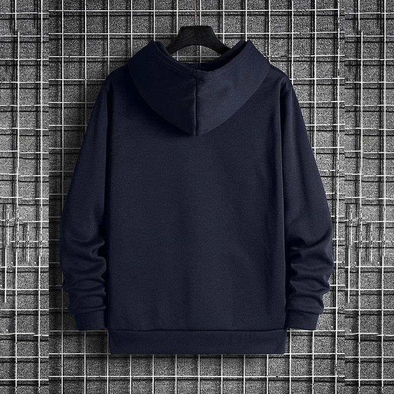 Navy blue hoodie on a hanger against a grid-patterned wall.