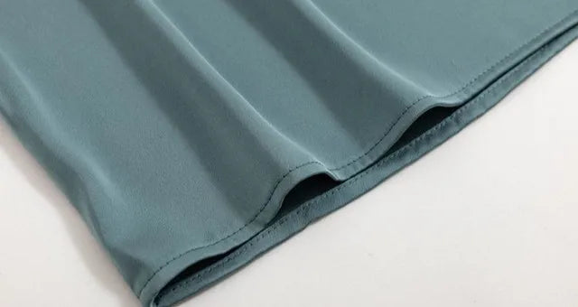 Teal fabric on a light Gray background