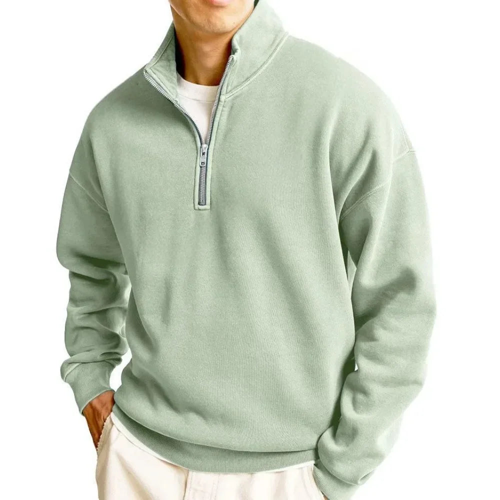 Light green pullover with a quarter zip on a white background