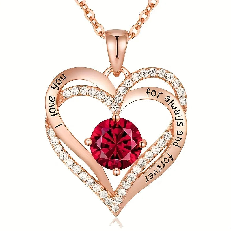 Heart-shaped rose gold pendant with Red gemstone and engraved text on a White background