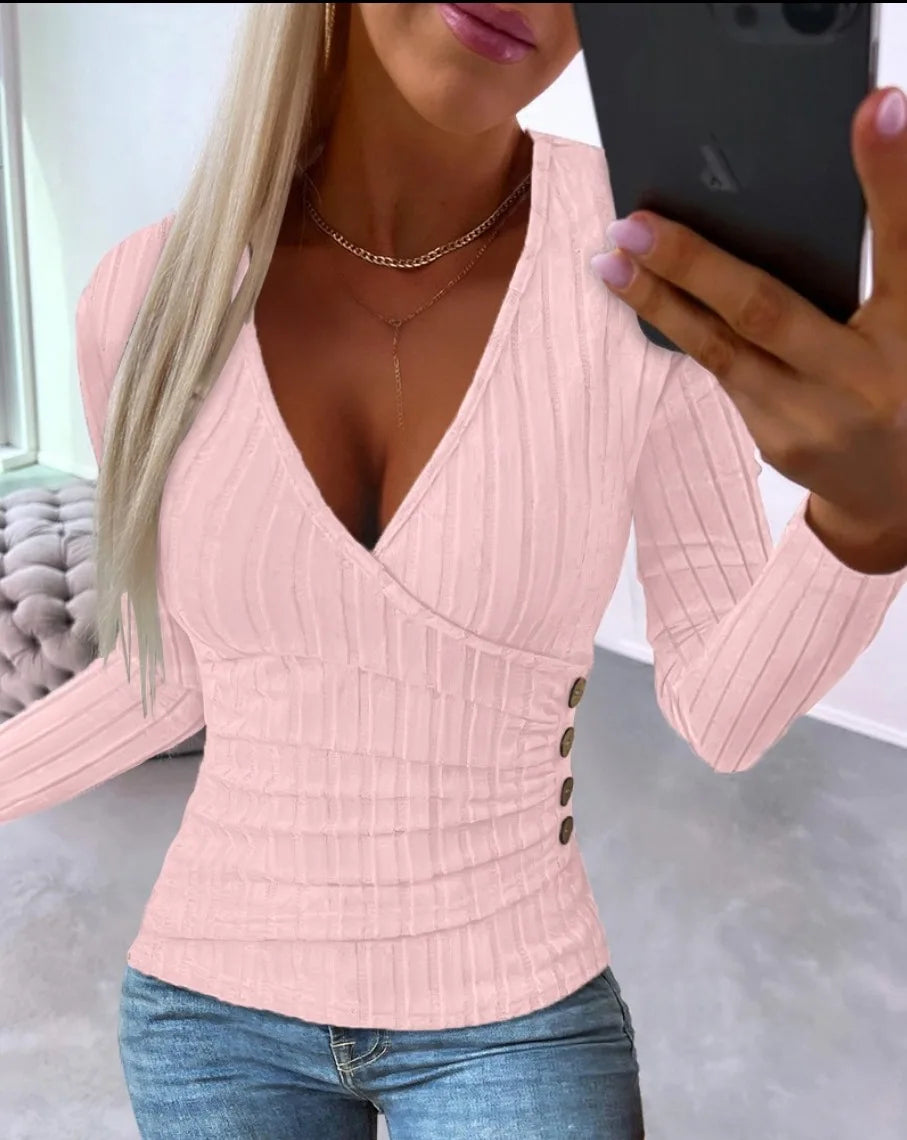 Person wearing a Pink ribbed top with buttons, taking a mirror selfie.
