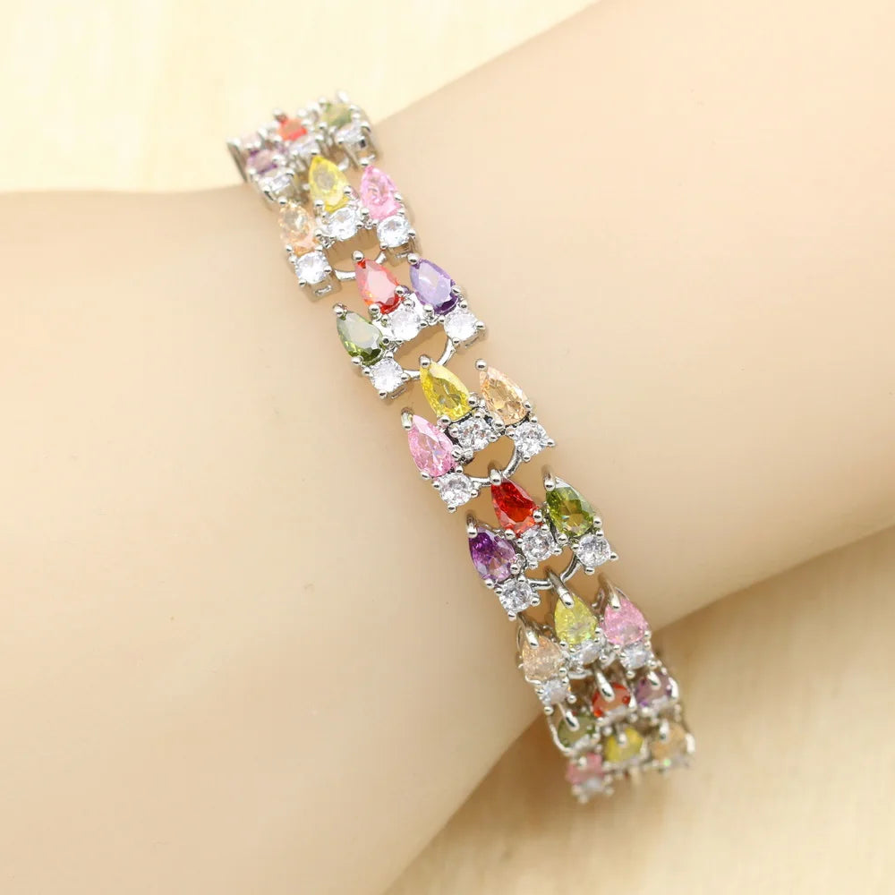 MulticoloRed gemstone bracelet on a wrist against a beige background