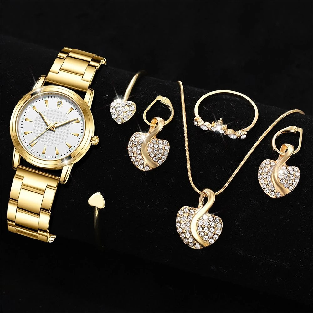 Gold watch and jewelry set including earrings, necklace, and ring on a Black background