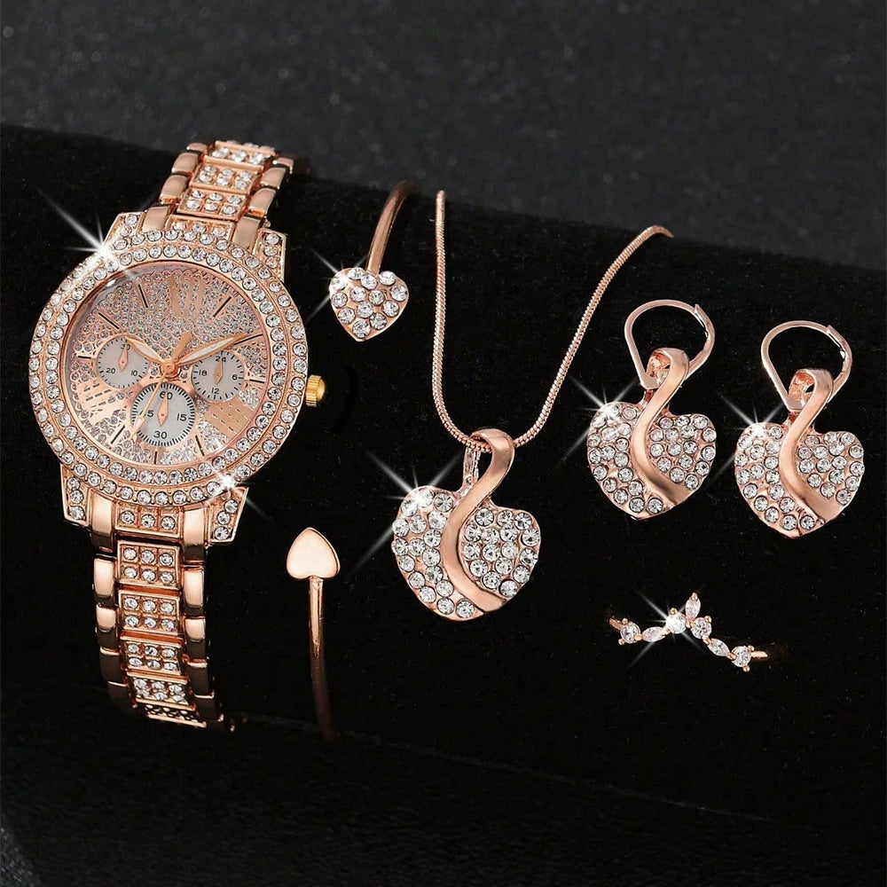 Rose gold watch and jewelry set on a Black background