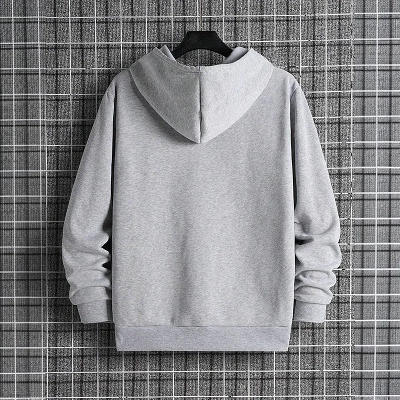 Gray hoodie on a hanger against a checkered background