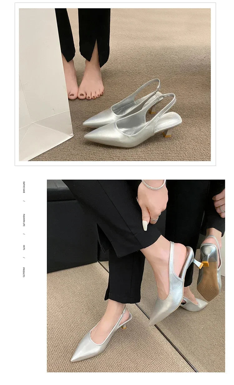 Silver high-heeled shoes worn by a person sitting on a beige carpet.