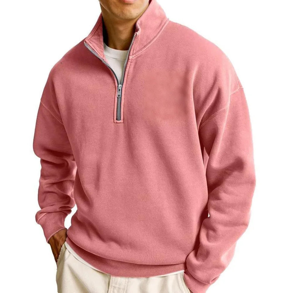 Person wearing a pink half-zip sweatshirt on a white background