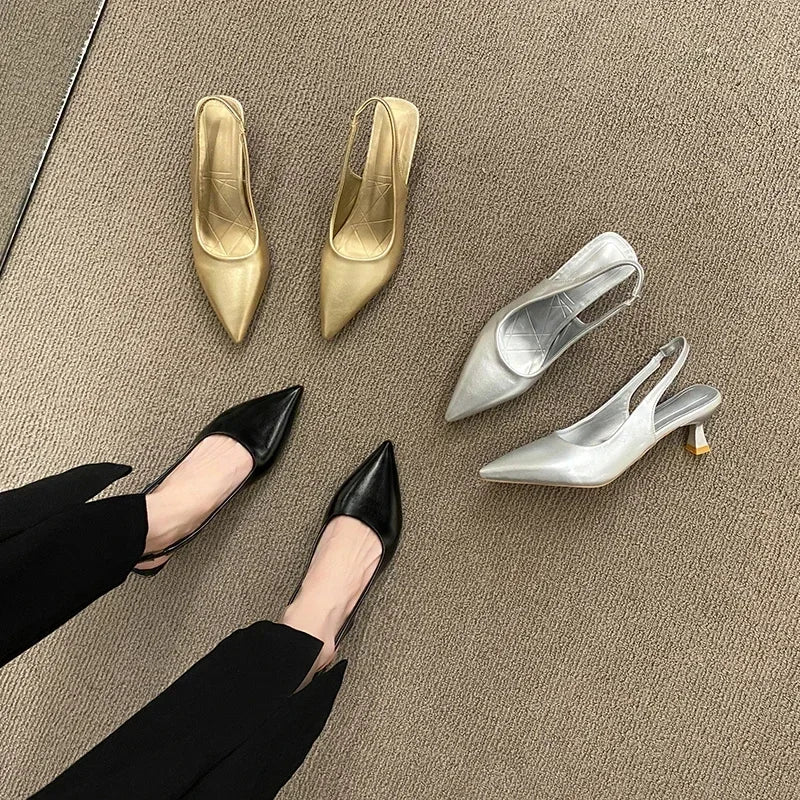 Black, gold, and silver high-heeled shoes on a beige carpet.