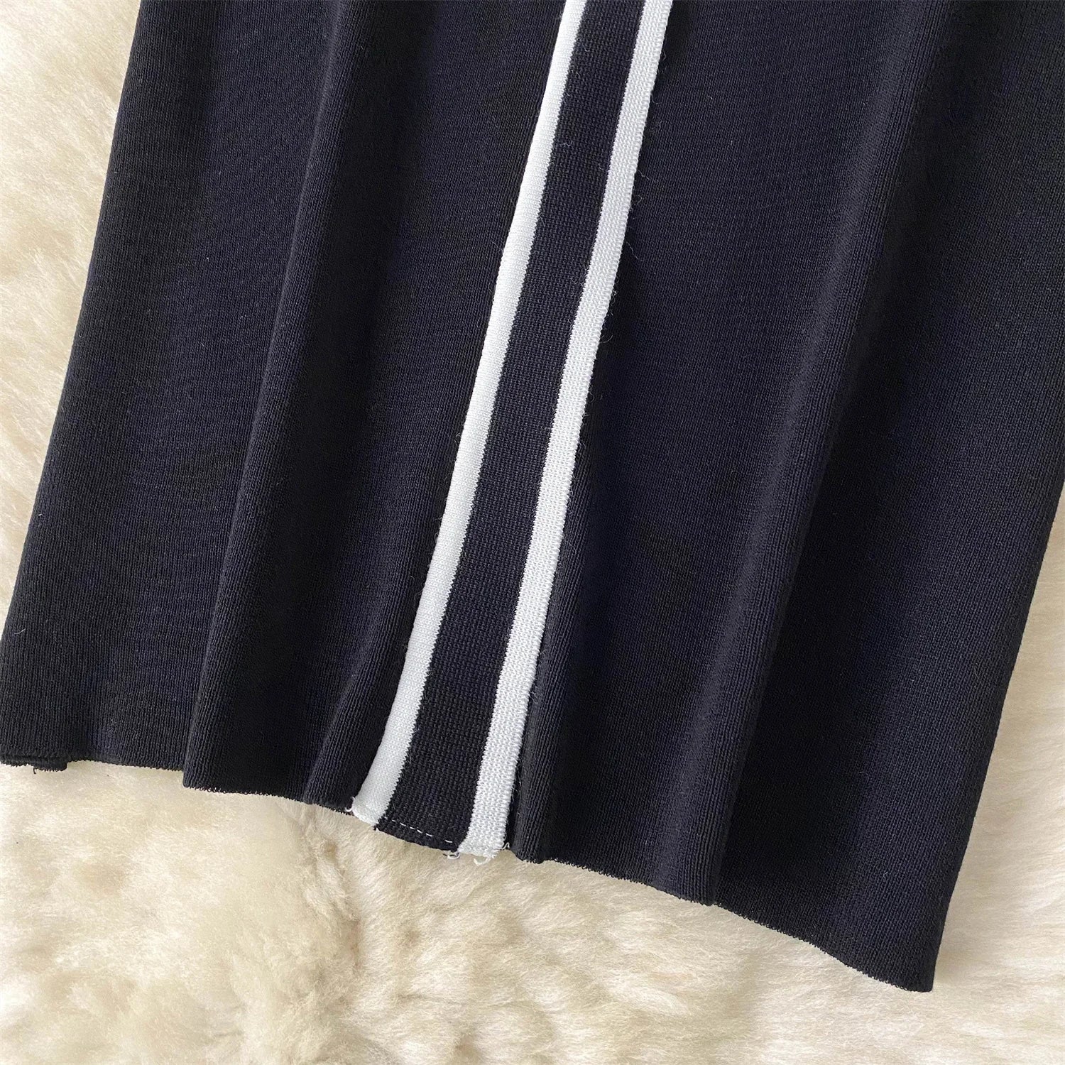 Close-up of a navy Blue fabric with White stripes on a beige background