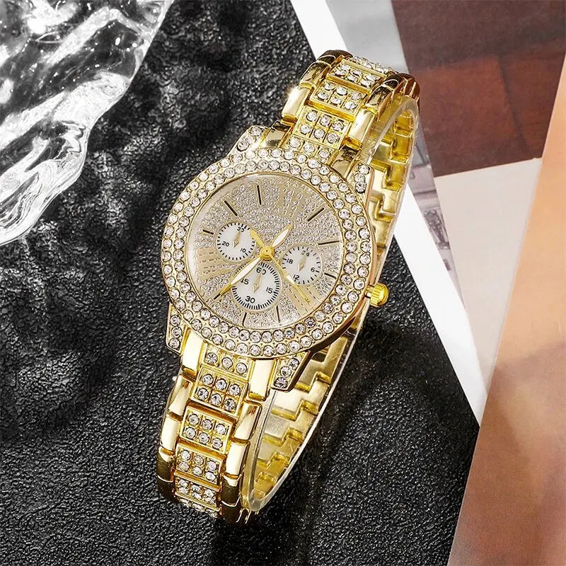 Gold wristwatch with diamond-studded band on a textuRed surface