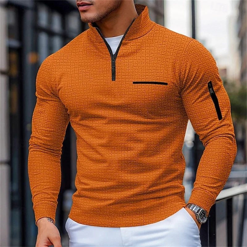 Orange long-sleeve shirt with a zipper detail worn by a person outdoors.