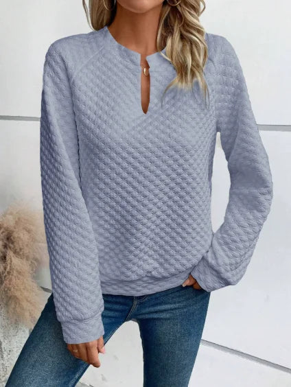 Person wearing a textuRed light Blue sweater with a White background