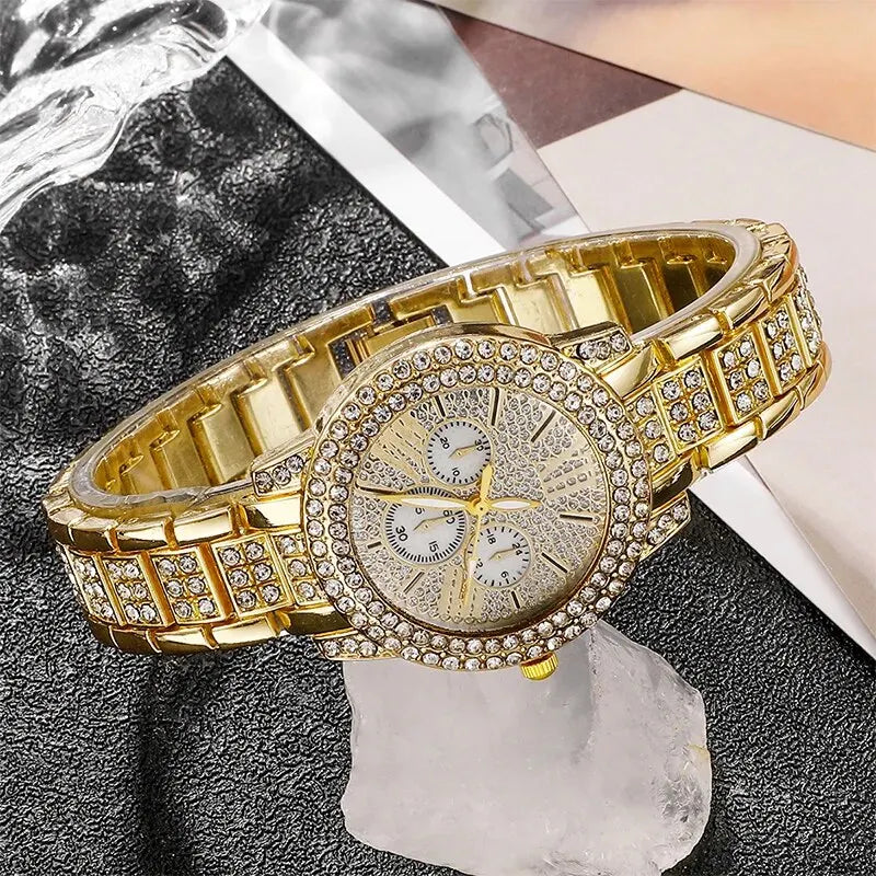 Gold wristwatch with diamond accents on a dark surface
