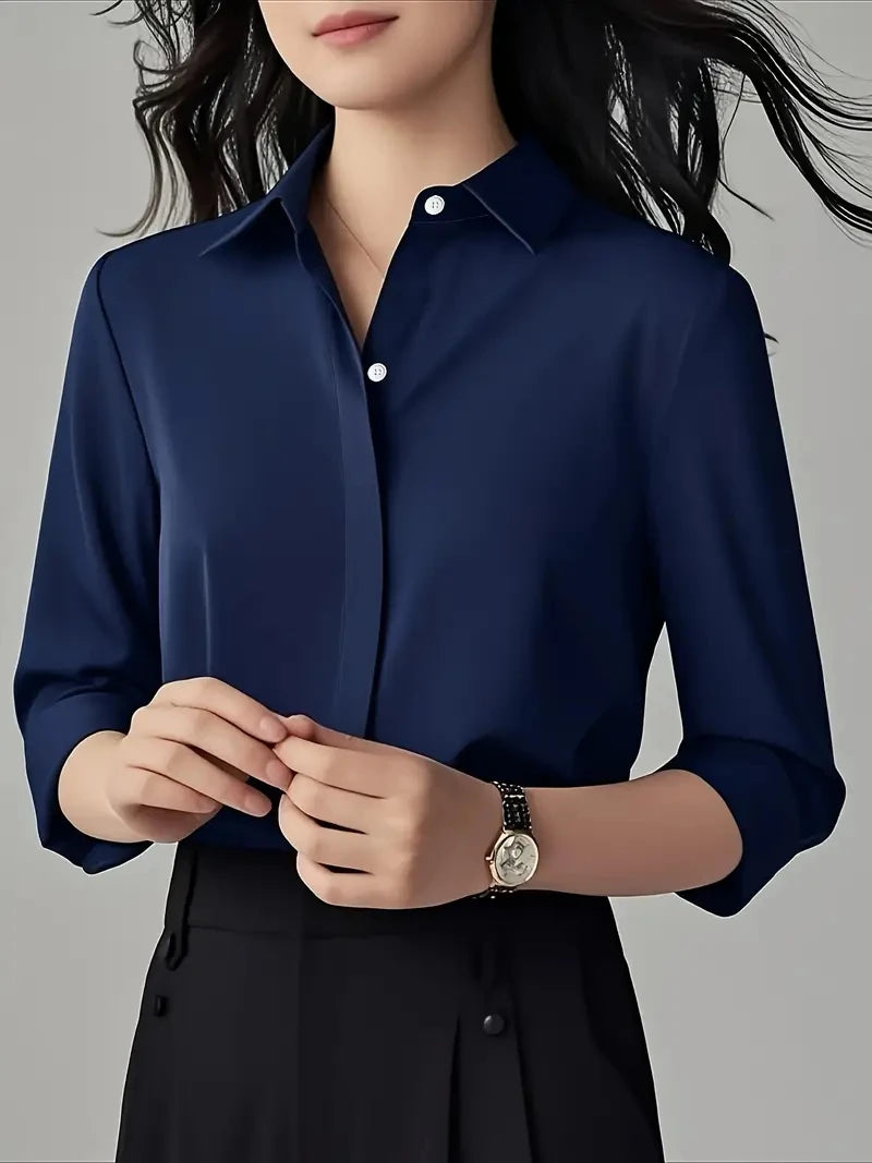 Person wearing a navy Blue shirt and Black pants with a Gray background