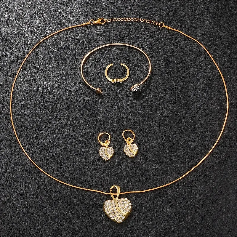 Gold jewelry set including necklace, bracelet, and earrings on a dark surface