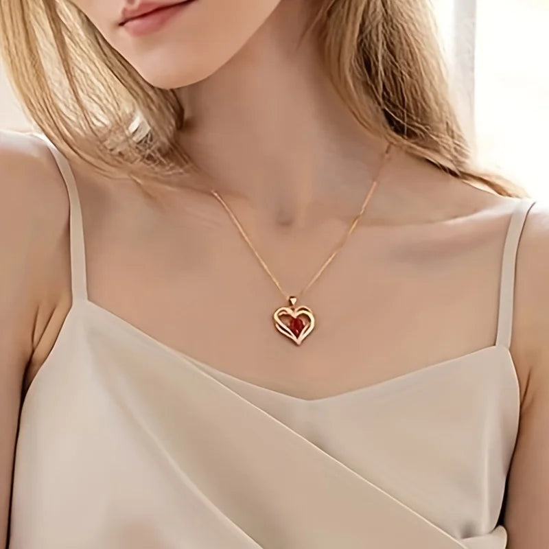 Woman wearing a gold necklace with a heart-shaped pendant
