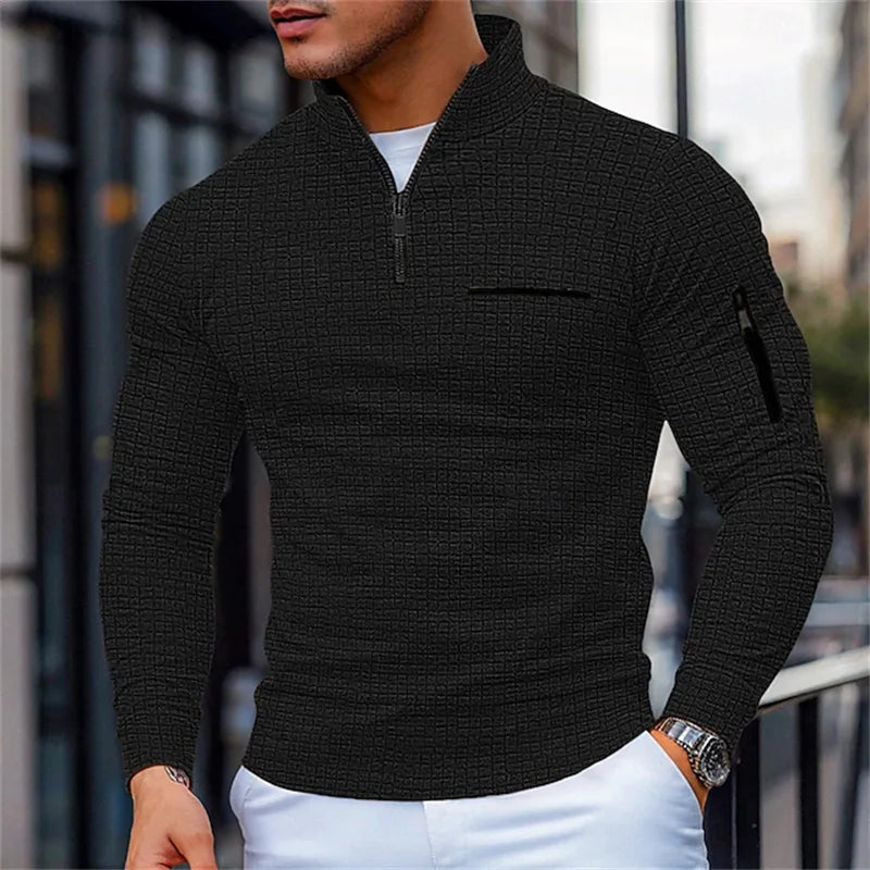 Man wearing a Black zip-up sweater with a blurRed cityscape background