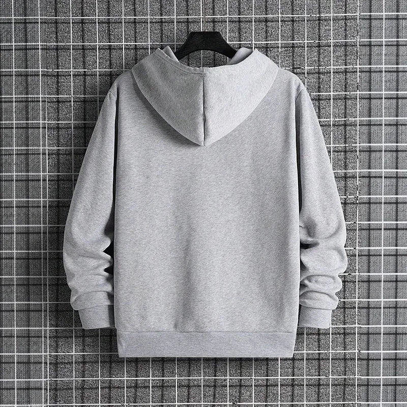 Gray hoodie on a hanger against a checkered background