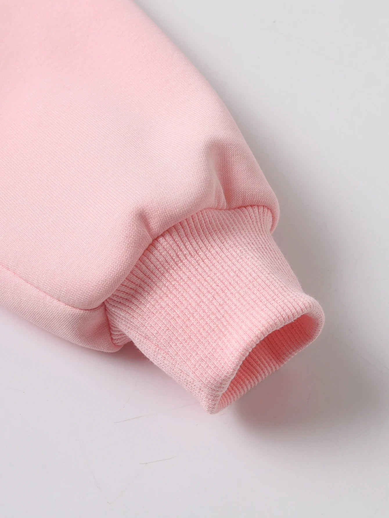 Close-up of a Pink fabric sleeve on a light Gray background