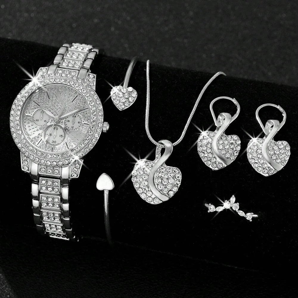 Silver jewelry set including a watch, necklace, and earrings on a Black background