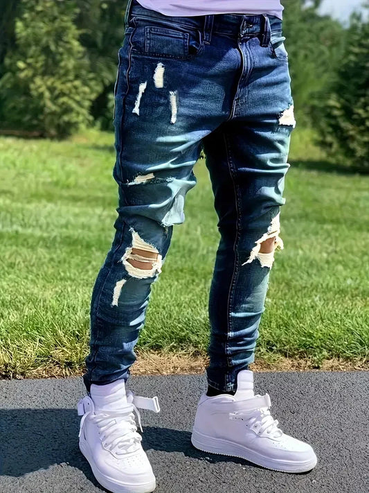 Person wearing ripped Blue jeans and White sneakers on a grassy background