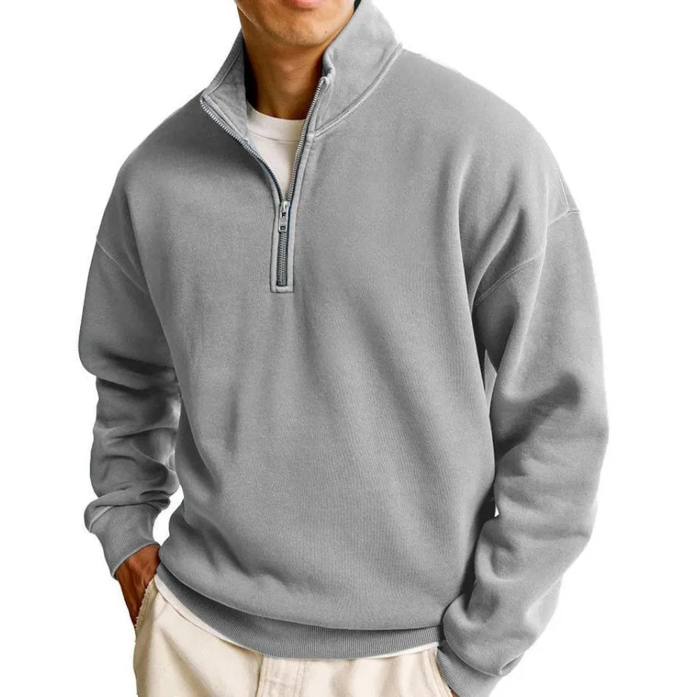 Gray quarter-zip pullover worn by a person on a white background