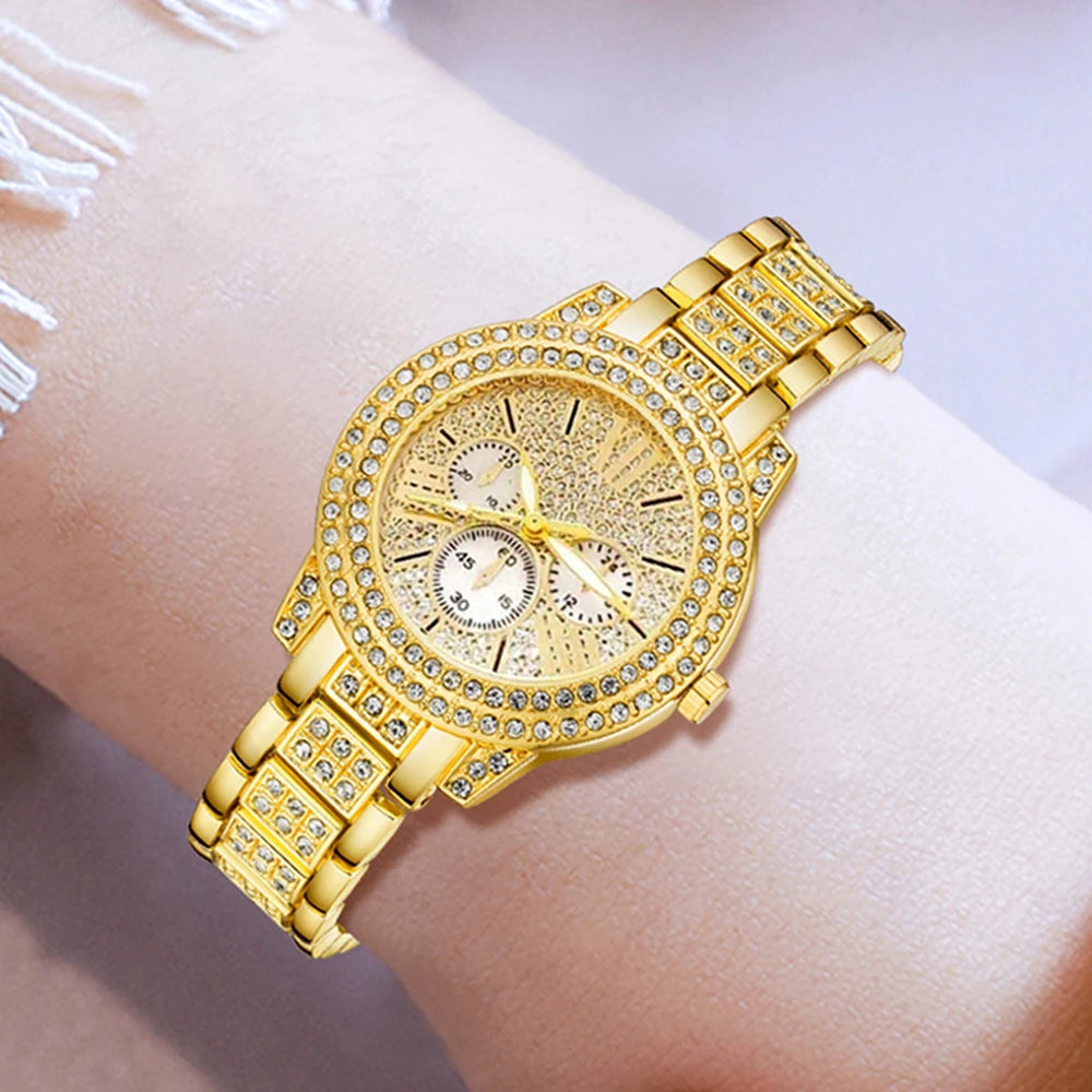 Gold wristwatch with diamond accents on a wrist against a light background