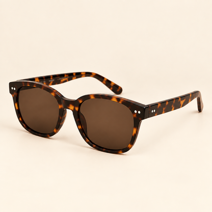 Vintage tortoiseshell sunglasses three-quarter view on warm cream background