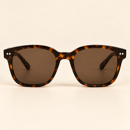 Vintage tortoiseshell sunglasses straight front view on warm cream background