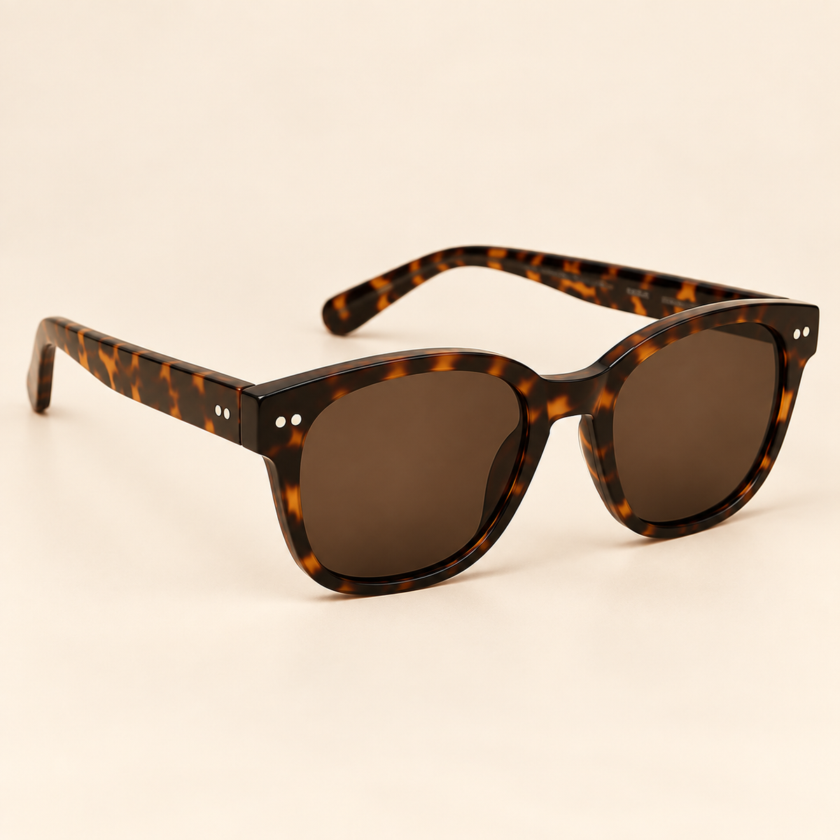 Vintage tortoiseshell sunglasses alternate three-quarter view on warm cream background