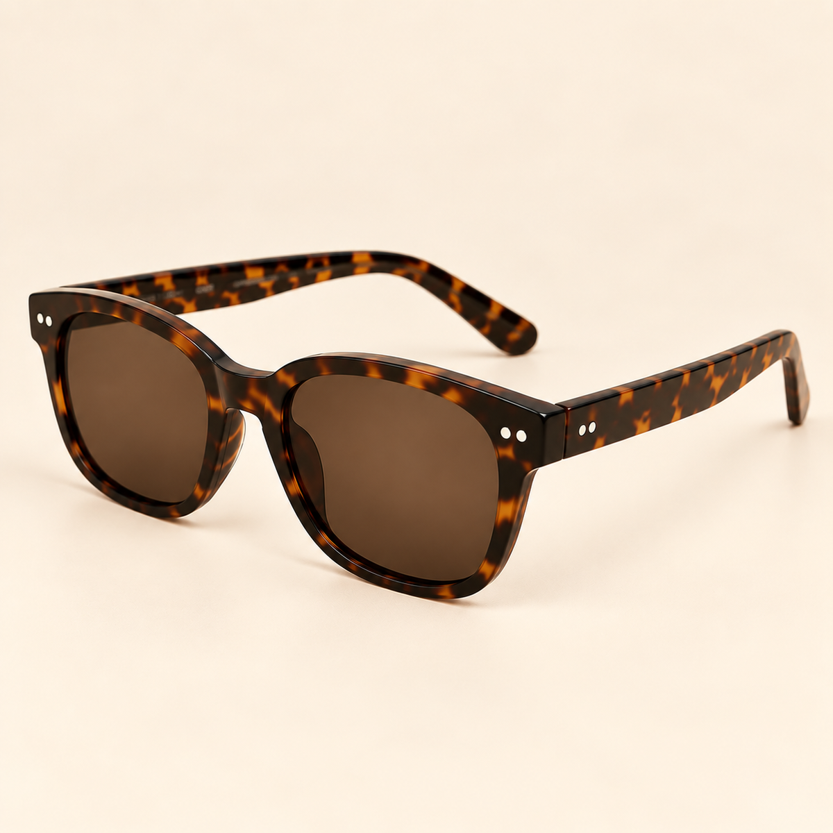 Vintage tortoiseshell sunglasses opposite angle on warm cream background