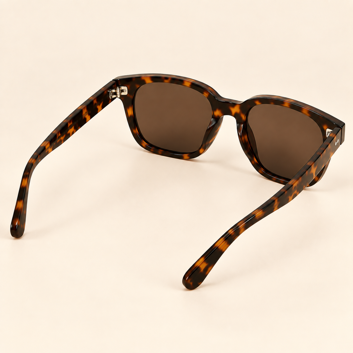 Vintage tortoiseshell sunglasses rear view on warm cream background