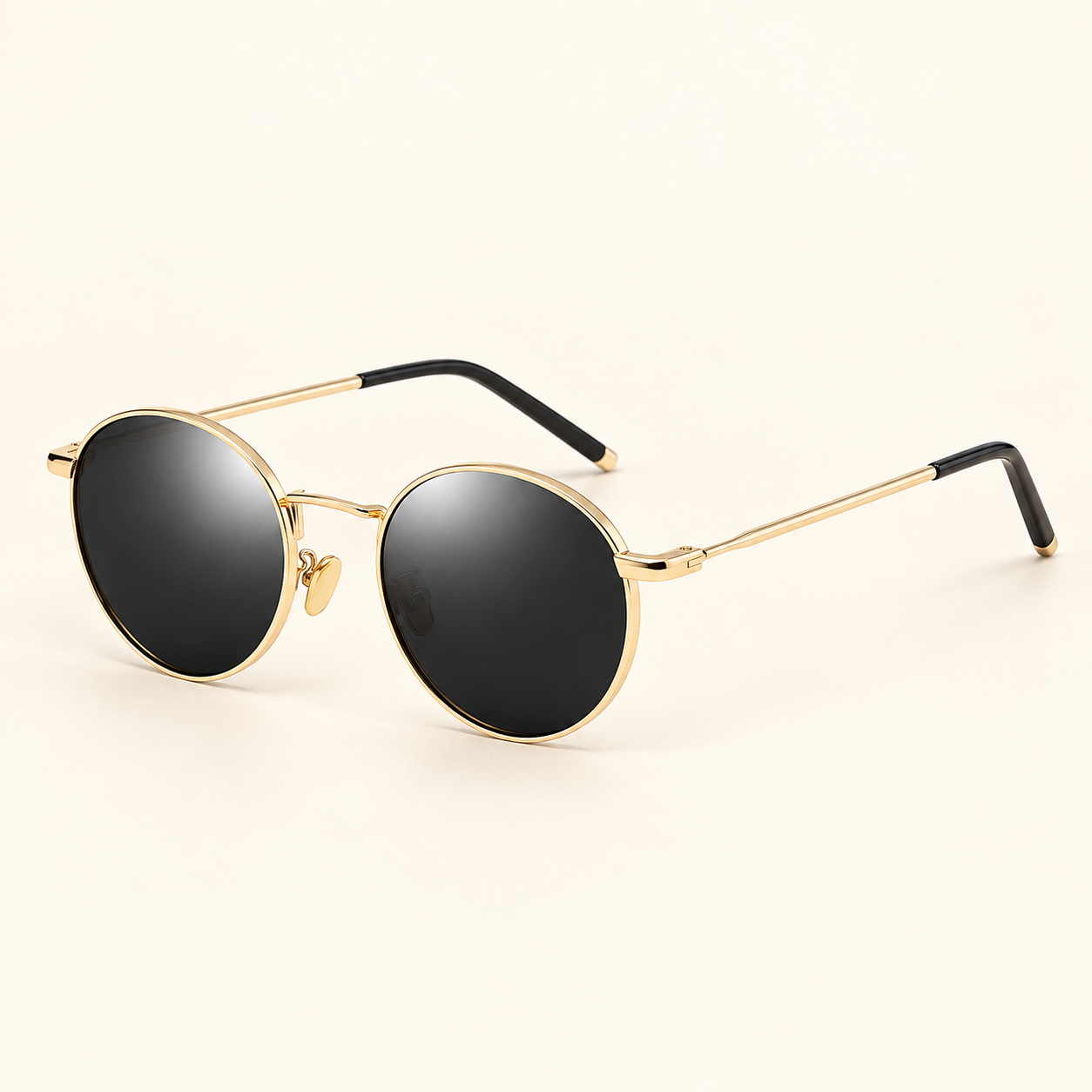 Women's round gold-frame sunglasses with dark lenses on cream background