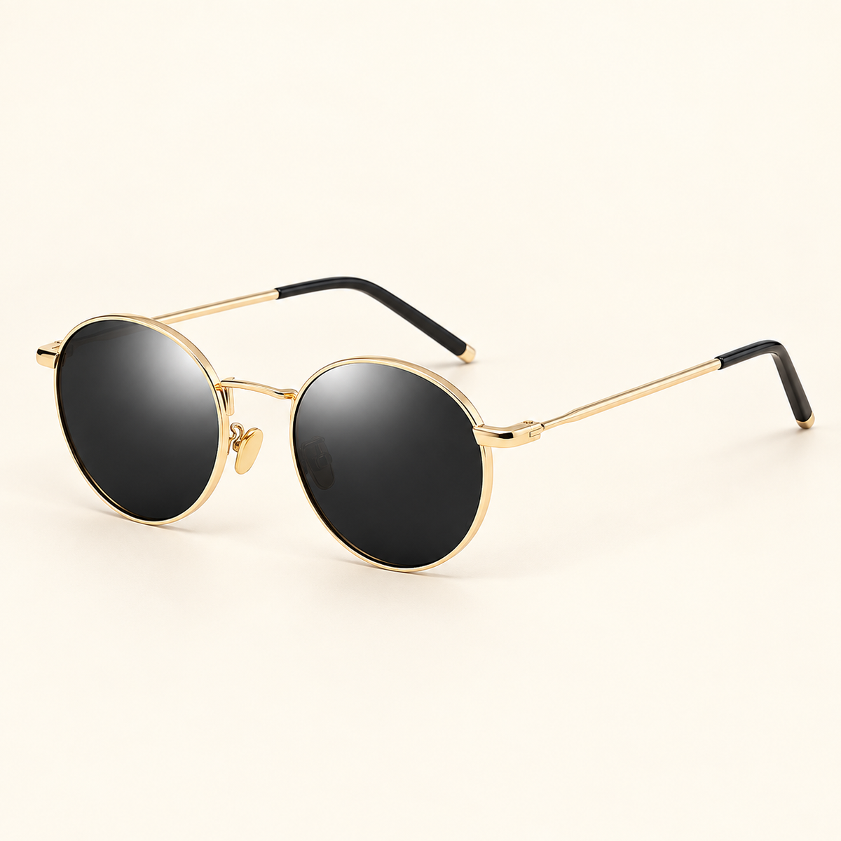 Women's round gold-frame sunglasses with dark lenses on cream background