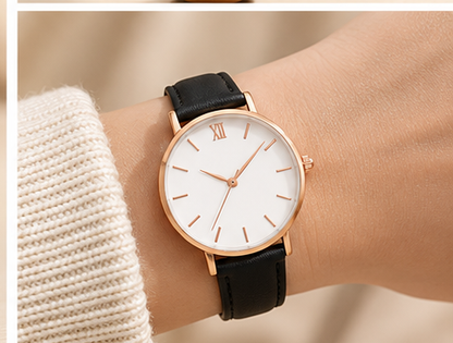 Women's minimalist quartz watch with black strap worn on wrist